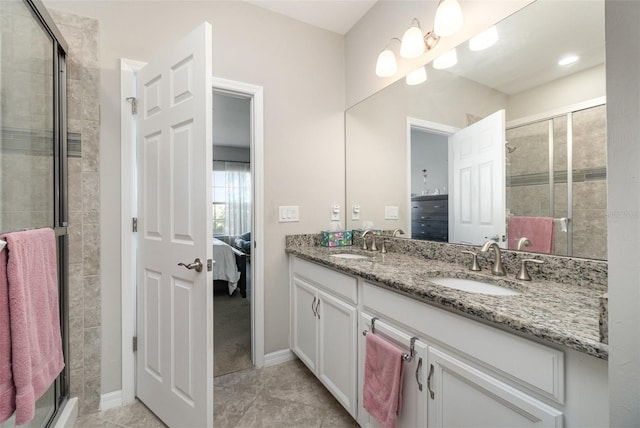 bathroom with tile patterned floors, a shower with door, and vanity