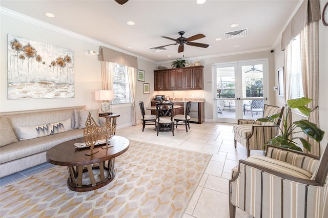 tiled living room featuring ceiling fan, french doors, and crown molding