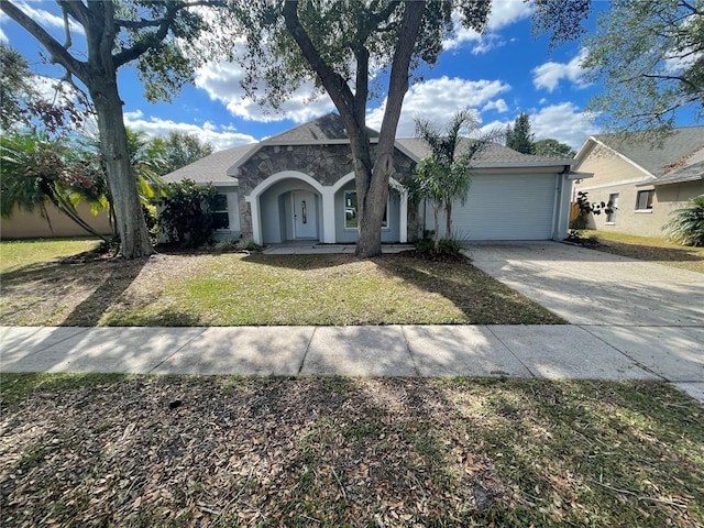 view of front of home featuring a garage and a front lawn