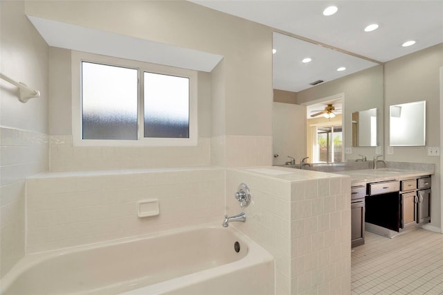 bathroom with vanity, a bathing tub, tile patterned floors, and ceiling fan