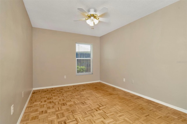 spare room with ceiling fan, a textured ceiling, and light parquet flooring