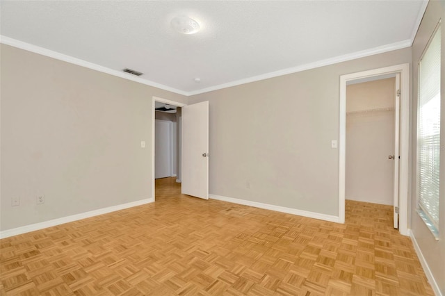 unfurnished room featuring crown molding, a healthy amount of sunlight, and light parquet floors