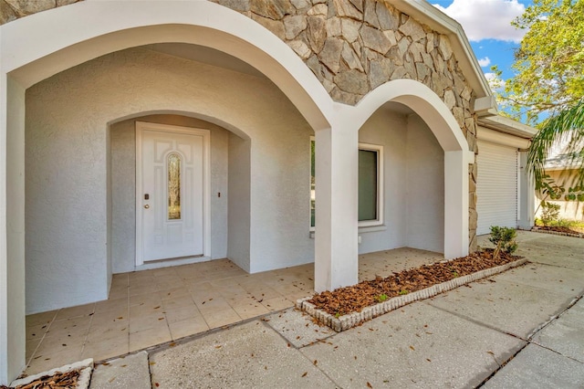 property entrance featuring a patio area