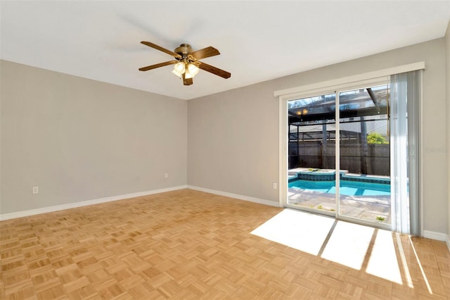 spare room featuring ceiling fan and light parquet floors