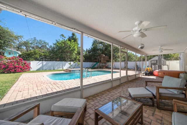 view of pool with outdoor lounge area, a patio area, a shed, and a playground