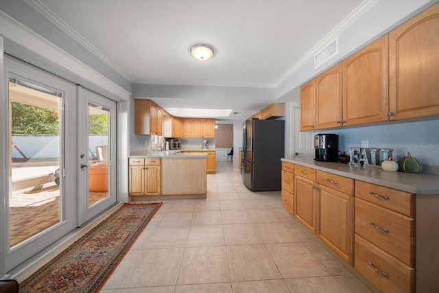 kitchen featuring stainless steel fridge, ornamental molding, light tile patterned floors, and french doors