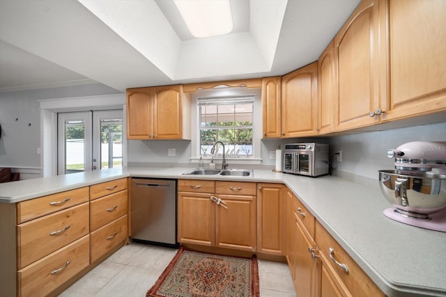 kitchen with french doors, stainless steel dishwasher, a healthy amount of sunlight, and sink