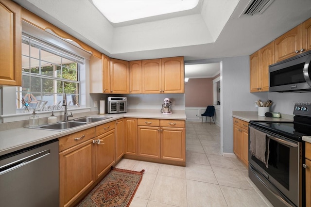 kitchen featuring sink, light tile patterned floors, and stainless steel appliances