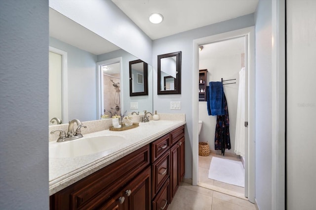 bathroom featuring toilet, vanity, tile patterned floors, and curtained shower