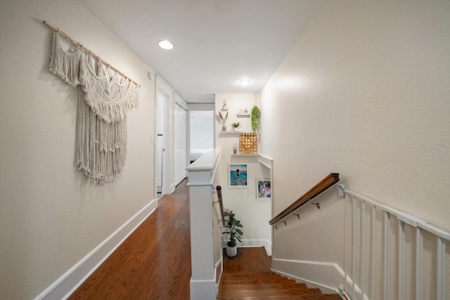 hallway with hardwood / wood-style flooring