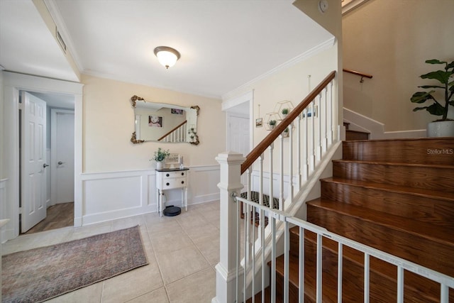 tiled foyer with ornamental molding