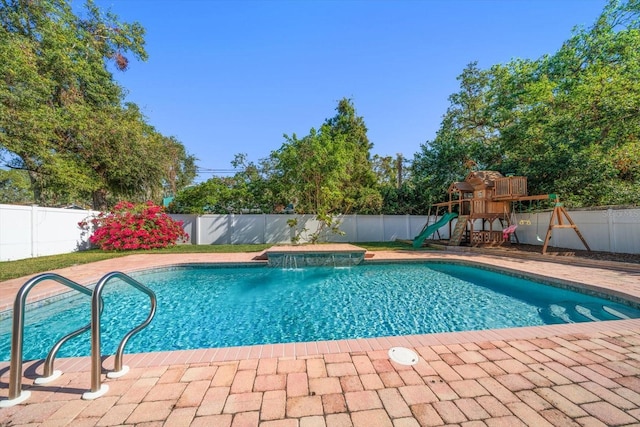 view of pool with pool water feature and a playground