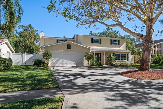 front facade featuring a garage and a front yard