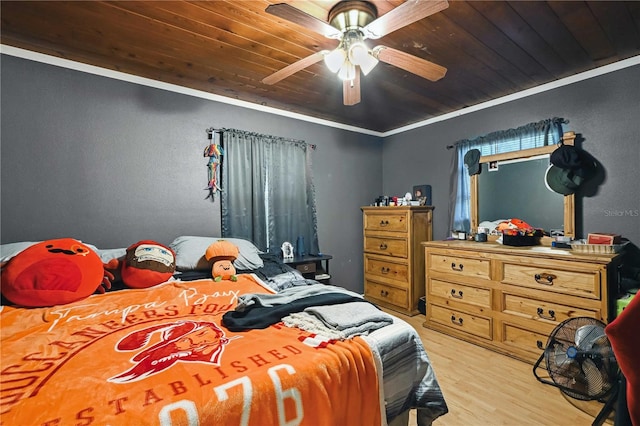 bedroom featuring ceiling fan, crown molding, wood ceiling, and light hardwood / wood-style flooring