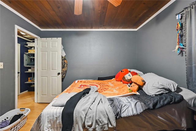 bedroom with hardwood / wood-style floors, crown molding, and wood ceiling