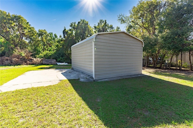 view of outdoor structure featuring a lawn