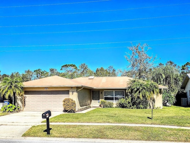 ranch-style home featuring a garage and a front lawn