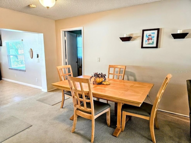 dining area with a textured ceiling