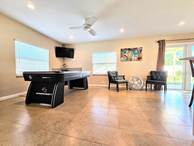 recreation room with light tile patterned floors and ceiling fan