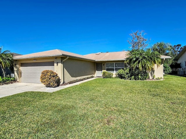 ranch-style home featuring a garage and a front lawn