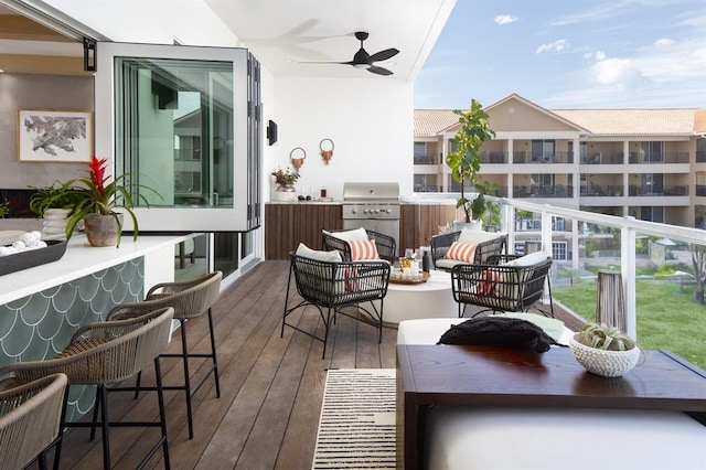 balcony with grilling area, an outdoor hangout area, and ceiling fan