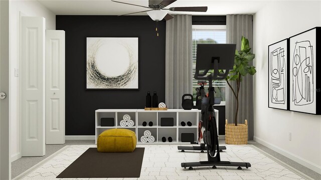 exercise area with light colored carpet and ceiling fan