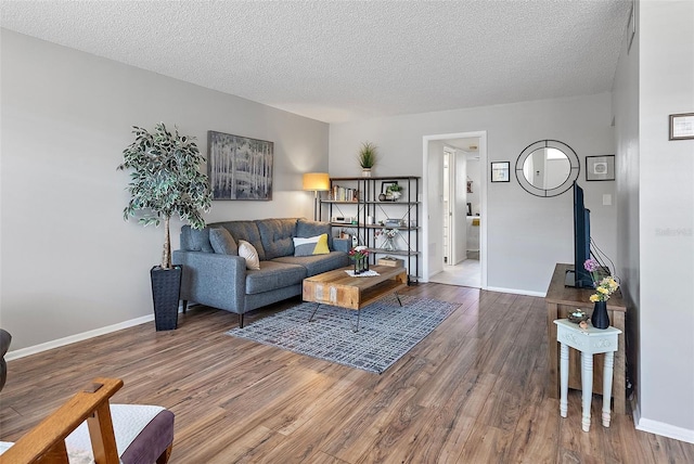 living room featuring a textured ceiling and hardwood / wood-style flooring