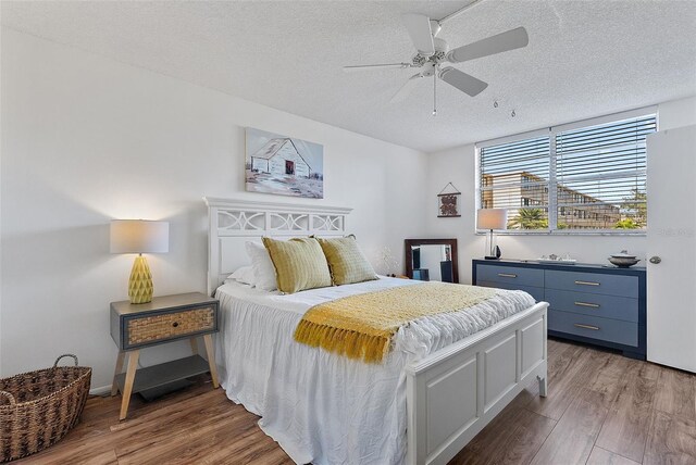 4915 Bay St NE Unit 130, Saint Petersburg, FL 33703 - bedroom with a textured ceiling, wood finished floors, and ceiling fan