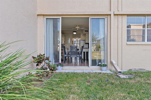 4915 Bay St NE Unit 130, Saint Petersburg, FL 33703 - view of exterior entry with stucco siding and a yard