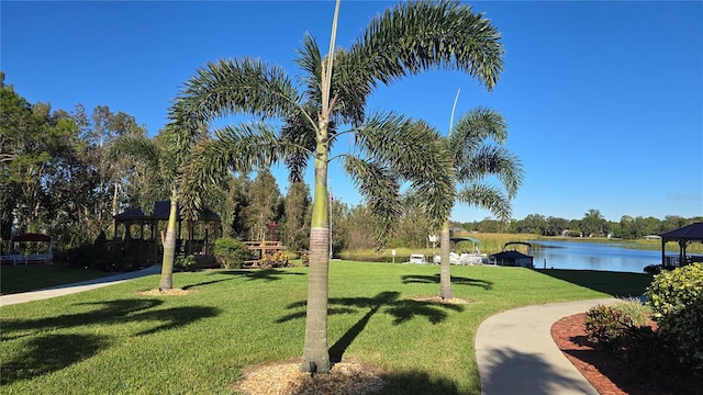 view of community featuring a gazebo, a lawn, and a water view