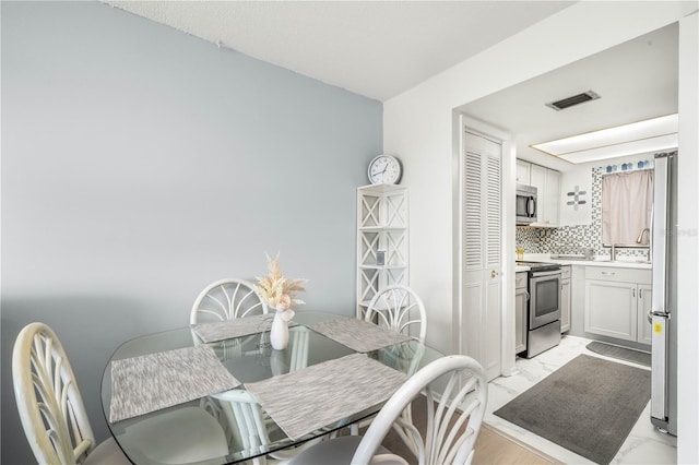 dining area with light wood-type flooring