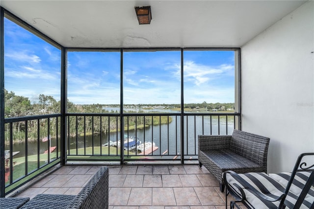 unfurnished sunroom featuring a water view