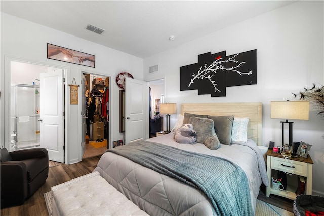 bedroom with dark hardwood / wood-style flooring, a spacious closet, and a closet