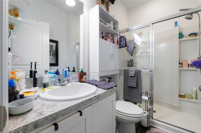 bathroom featuring vanity, toilet, and walk in shower