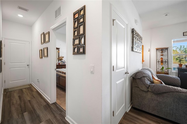 corridor with dark hardwood / wood-style flooring