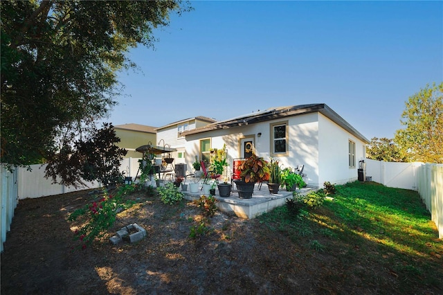 rear view of property featuring a yard