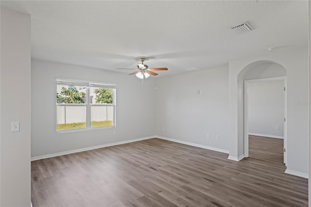 spare room with ceiling fan and dark hardwood / wood-style floors