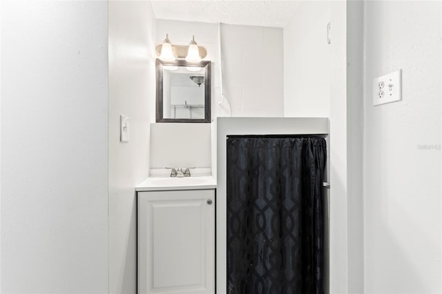 bathroom featuring vanity and a textured ceiling