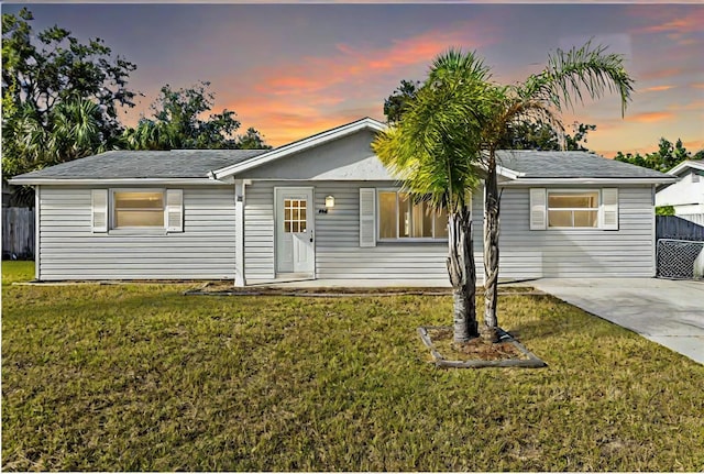 ranch-style home with a yard