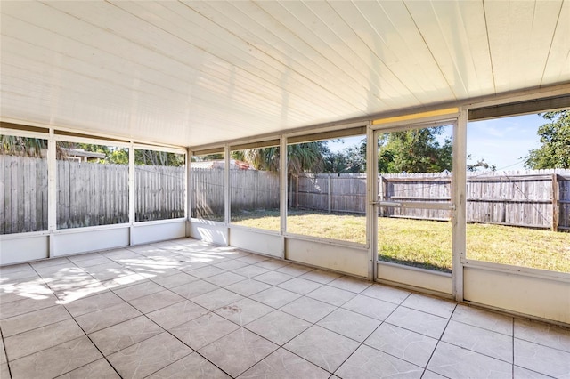 unfurnished sunroom featuring plenty of natural light and wood ceiling