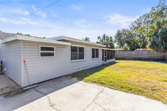 rear view of property with a yard and a patio