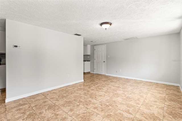 spare room with a textured ceiling