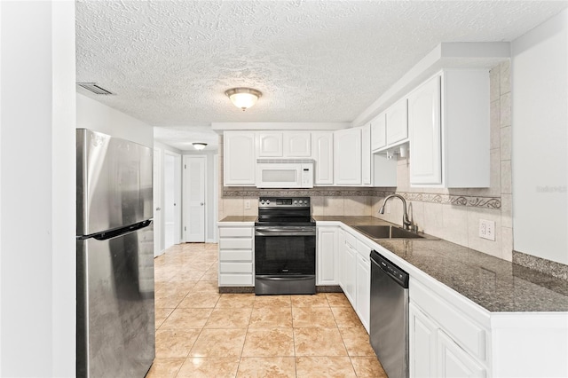 kitchen with backsplash, sink, white cabinetry, and stainless steel appliances