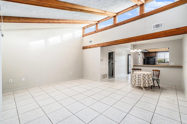 unfurnished living room featuring beam ceiling, light tile patterned floors, high vaulted ceiling, and an inviting chandelier