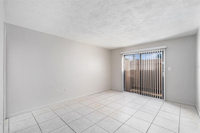 tiled spare room with a textured ceiling