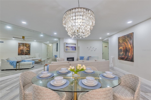 dining space featuring light hardwood / wood-style floors and an inviting chandelier