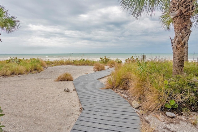 view of property's community featuring a beach view and a water view