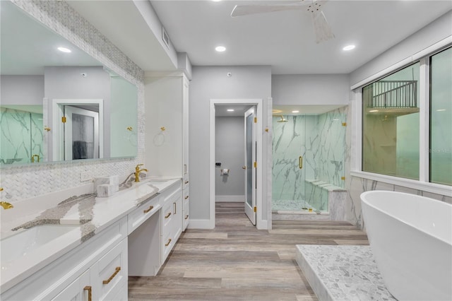 bathroom featuring separate shower and tub, vanity, tasteful backsplash, and hardwood / wood-style flooring