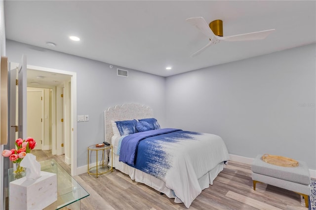 bedroom with ceiling fan and light hardwood / wood-style floors