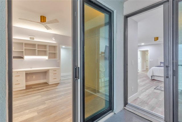 interior space featuring built in desk and light hardwood / wood-style floors